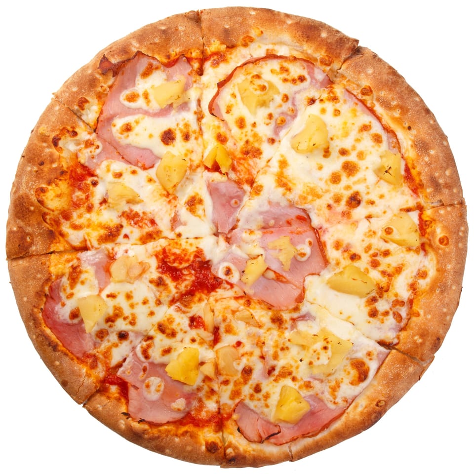 Wicked Pizza Company's Hawaiian pizza, topped with ham, pineapple, and melted cheese, sliced and ready to eat.